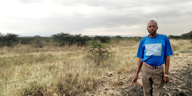 Simon Saigilu stands next to an electric fence that often fails, allowing lions from the nearby reserve to enter his village. Photo / The Washington Post / Kevin Sieff