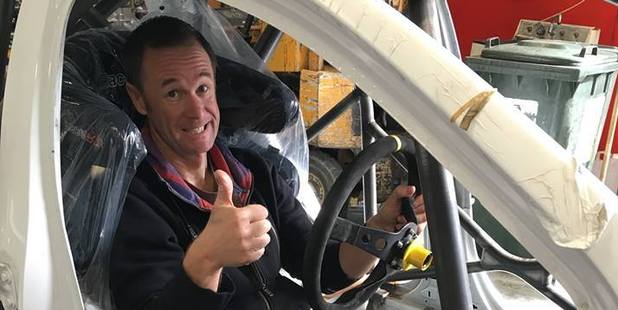 Greg Murphy sits in the shell of the new AP4 Holden Barina. Photo / Holden Barina RallySport