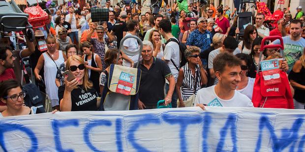Hundreds of angry Venetians have protested tourism in their city, brandishing shopping carts and prams. Photo / Facebook