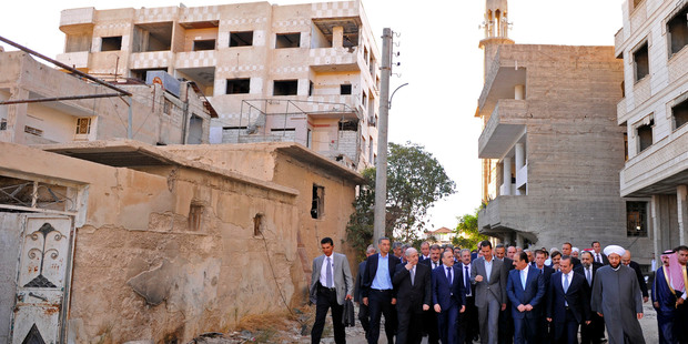 In this picture released by the Syrian official news agency SANA, Syrian President Bashar al-Assad, centre, in Daraya. Photo / AP