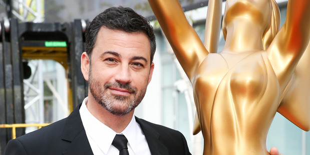 Host Jimmy Kimmel poses for a photo with an Emmy statue at the Primetime Emmy Awards. Photo/AP