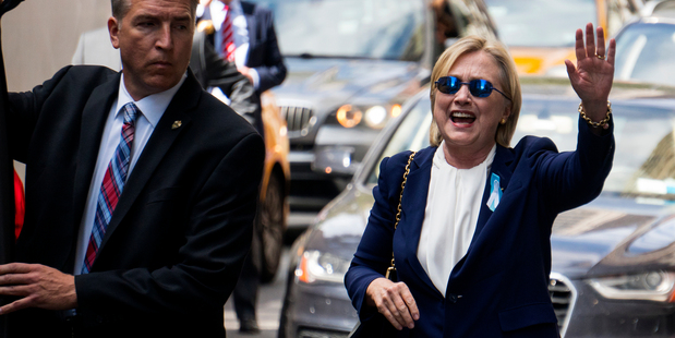 Democratic presidential candidate Hillary Clinton waves as she walks from her daughter's apartment building in New York yesterday. Photo / AP