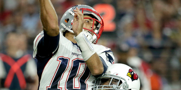 New England Patriots quarterback Jimmy Garoppolo is hit against the Arizona Cardinals. Photo / AP