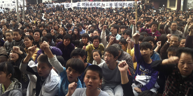 Villagers chant slogans as they gather for the 2011 protest in Wukan village, Lufeng city, in southern China's Guangdong province. Photo / AP
