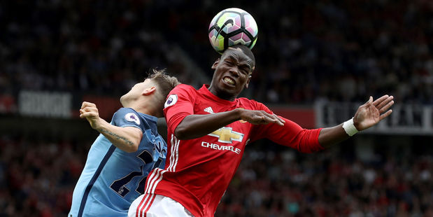 Manchester United's Paul Pogba (right) and Manchester City's John Stones battle for the ball during City's 2-1 win at Old Trafford early this morning (NZT). Photo / AP