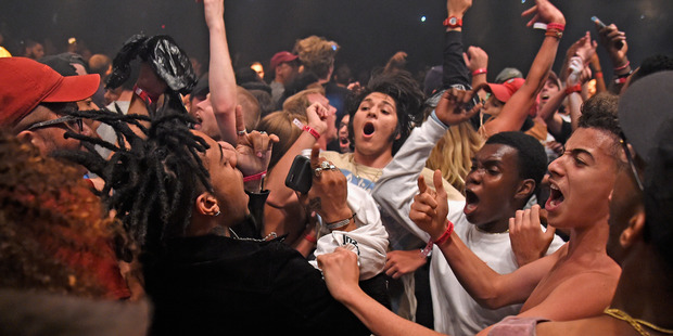 Rapper Vic Mensa (C) moshes in the crowd during Kanye West: The Saint Pablo Tour. Photo / Getty