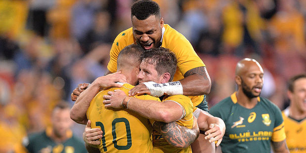 Bernard Foley of the Wallabies is congratulated by team mates after scoring a try. Photo / Getty