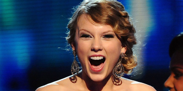 Taylor Swift receives an award onstage at the 52nd Annual GRAMMY Awards. Photo / Getty