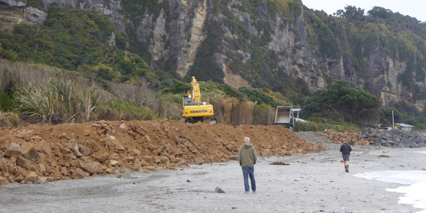 Debris from Sunday's big slip which has closed the Coast Road is being dumped beside the Punakaiki Beach Camp to help protect it from the sea. Photo / Teresa Smith