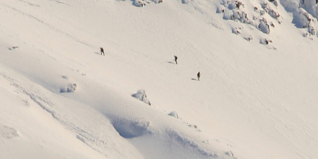 Three trampers are seen on Mt Taranaki, before they were rescued by helicopter late on Sunday evening Photo by Kristina Wetherill , supplied to the NZ Herald