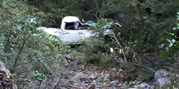 A rescue team works to retrieve the occupants of a 4WD that ran off the road at Makaroa near Queenstown. Photo / Supplied