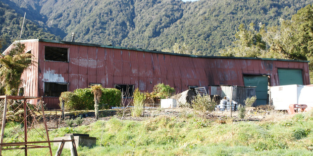 Today detectives and fire investigators were sifting through the burned-out shell of the mechanical business to determine what happened. Photo / Greymouth Star