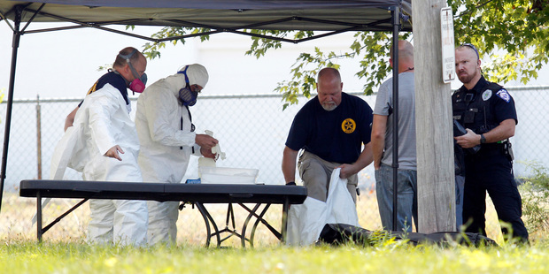 Ashland Police don forensics gear to inspect the house. Photo / AP