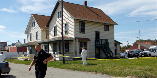 Ashland Police Department and Ohio BCI execute a search warrant on a home where a woman was held captive. Photo / AP
