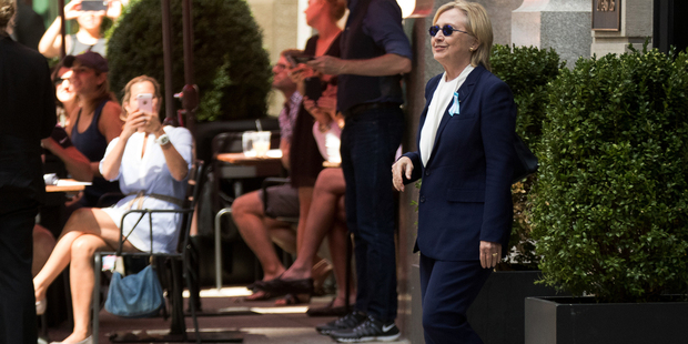 Is that the real Hillary Clinton exiting the building? Speculation has been rife that there was a body double standing in for the Democrat. Photo / AP