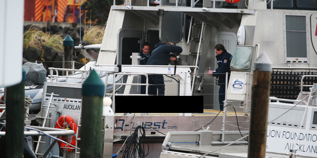 Police photograph a deceased man, Alaric Eccleston, onboard a police launch today at Mechanics Bay, Auckland. (Image altered to obscure Eccleston). Photo / Doug Sherring