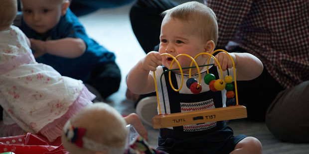 Prince George plays with the toys during a Plunket nurse and parents group visit at Government House in Wellington. Photo / Marty Melville