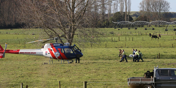 One of the injured people were carried by stretcher to the BayTrust Rescue Helicopter on Monday. Photo/John Borren