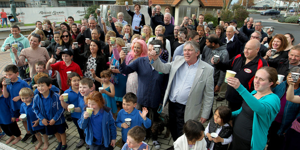 Cheers: Havelock North Business Association president Sam Jackman toasts the quality of the water with other supporters confirming Havelock North is getting back on its feet.