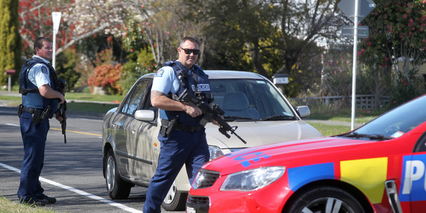 Armed police check out a car coming out of a cordon in Napier. Photo: Duncan Brown.