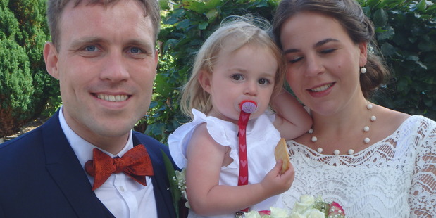 Groom and bride with their daughter. Photo / Debra Christensen