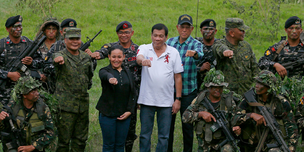 Philippine President Rodrigo Duterte poses with Philippine Army Scout Rangers at their headquarters at Camp Tecson in San Miguel, north of Manila. Photo / AP