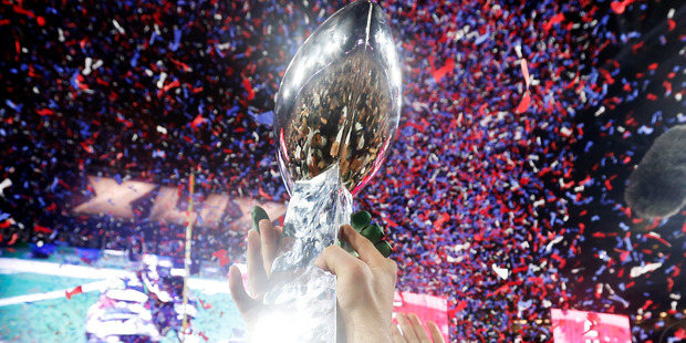 Members of the New England Patriots celebrate with the Vince Lombardi Trophy after defeating the Seattle Seahawks 28-24 in Super Bowl XLIX at University of Phoenix Stadium. Photo / Getty