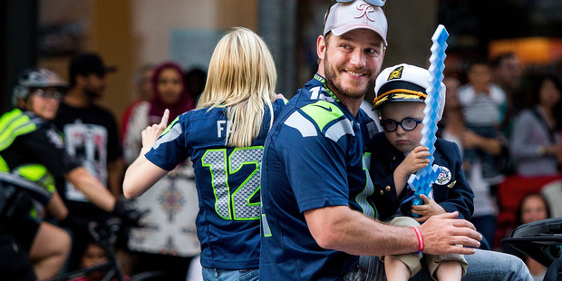 Actor Chris Pratt and son Jack Pratt ride in the Seafair Torchlight Parade Grand Marshal vehicle on July 30, 2016 in Seattle, Washington. Photo / Getty