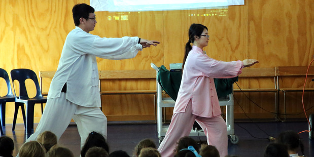 Chinese teachers Ming Ma (left) and Tory Shi demonstrate tai chi for students at St Marcellin School.PHOTO/STUART MUNRO
