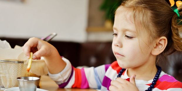 Parents who give their children junk food just to make sure they eat may be setting them up for later obesity. Photo / 123RF