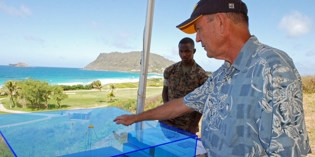 Patrick Cross, specialist at the Hawaii Natural Energy Institute at the University of Hawaii at Manoa, shows a model of the Lifesaver wave energy machine. Photo / AP