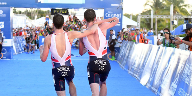 Alistair Brownlee, right, helps his brother Jonny to get to the finish line during the Triathlon World Series event in Cozumel Mexico. Photo / AP