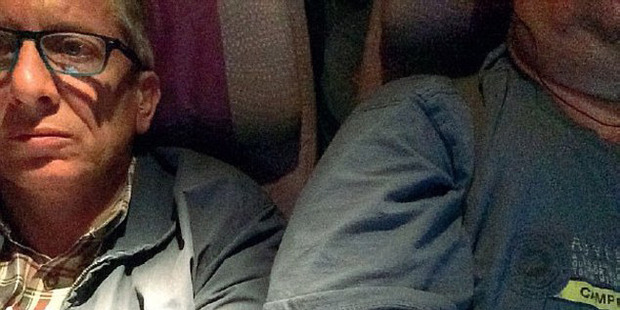 Italian lawyer Giorgio Destro (left), captured his predicament on the Emirates flight from Cape Town to Dubai by taking a selfie of his overweight seat neighbour (right) as evidence. Photo / Supplied