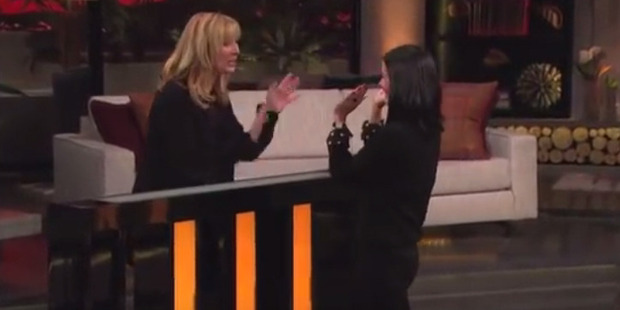 Lisa Kudrow and Courteney Cox high five after a Friends trivia game.