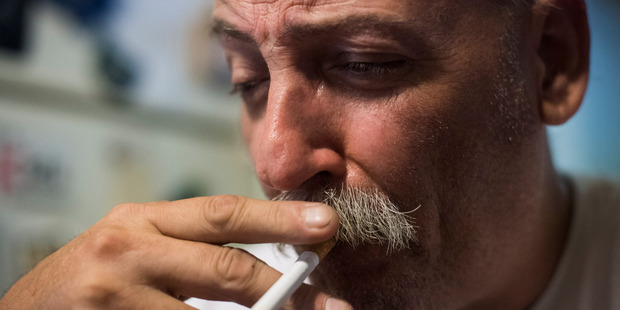 Jim Cooley smokes a cigarette as he rests after doing errands at his home in Winder, Ga. Photo / The Washington Post / Jabin Botsford