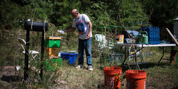 Jim Cooley feeds bees at his home in Winder, Ga. Photo / The Washington Post/ Jabin Botsford