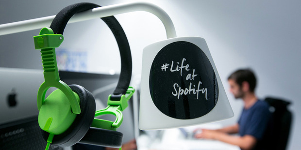 Spotify operates a larger paid subscription service and has showed no signs of slowing down since Apple Music began competing in that market. Photo / Bloomberg