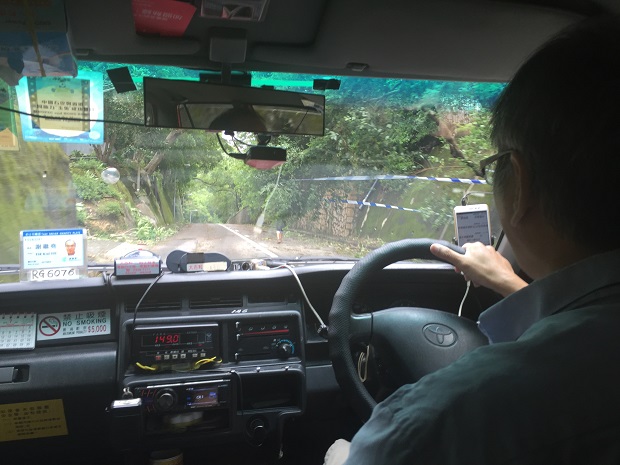 Dodging the storm debris in a taxi on the way to Big Wave Bay. Photo / Grant Bradley