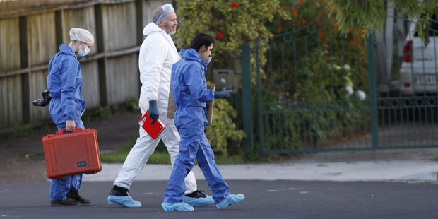 Yesterday officers in forensic suits worked behind the cordon. Photo / Nick Reed