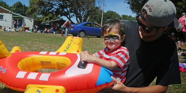 FLYING: Connor Haddon-Moana with dad Josiah Moana was happy to find this inflatable toy at the market in Duncan St yesterday. PHOTO/BEVAN CONLEY
