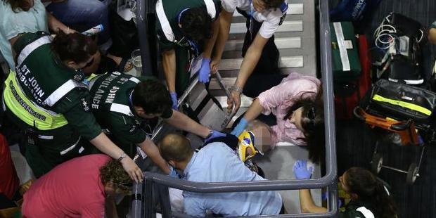 Paramedics provide attention to an injured patron at the Australian Open. Photo / Getty