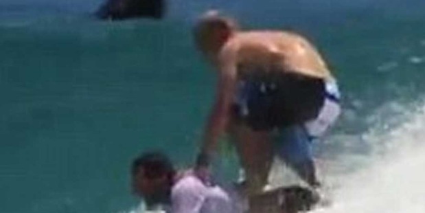 Custom board: The professional surfer opted to ditch his board and use the back of the man instead. Photo / Facebook.