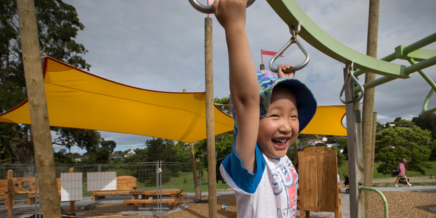 Tianze Wang, 3, of Eastern Auckland, plays on the playground at Sherwood Reserve where new sunshades have gone up. Photo / Nick Reed