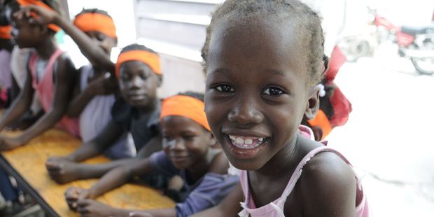 A school student sharing a laugh while in class in a small school in Hait. Photo / 123RF