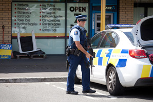 Police outside the Hammer Hardware and Lotto in the Te Ngae Shopping Centre. Photograph by Andrew Warner.