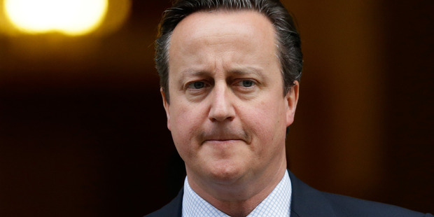 David Cameron says he will back public authorities that put in place "proper and sensible" rules to ban women from wearing face veils in comments which will reignite debates. File Photo / AP.