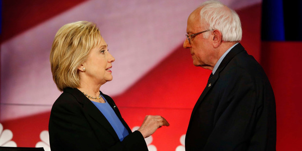 Democratic presidential candidate, Hillary Clinton and Democratic presidential candidate, Sen. Bernie Sanders speak during a break at the NBC, YouTube Democratic presidential debate. Photo / AP
