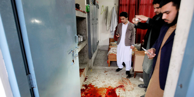 Pakistani students look at a pool of blood following an attack at Bacha Khan University in Charsadda. Photo / AP