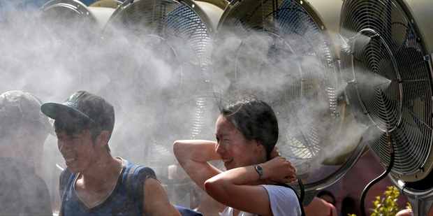 Fans cool off at the Australian Open - which has a sports betting site as a sponsor in the same year a fixing scandal has hit tennis. Photo / AP