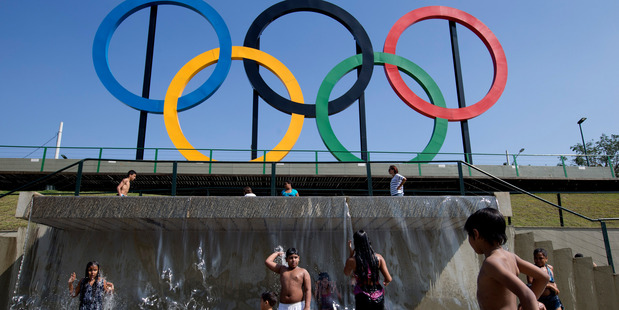 Children play in a water fountain next to Olympic rings at Madureira Park in Rio de Janeiro. photo / AP